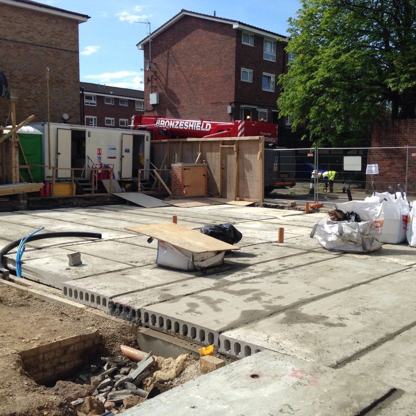 Precast hollowcore ground floor slabs laid with a mobile crane behind